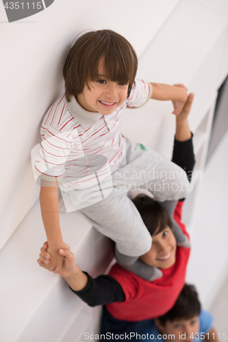 Image of young boys posing line up piggyback top view