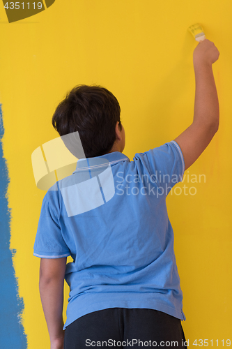 Image of Portrait of a happy young boy painter