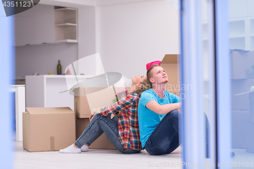 Image of young couple moving  in new house