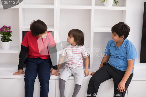 Image of young boys posing on a shelf