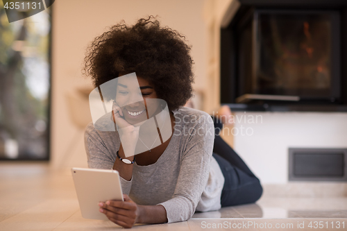 Image of black women using tablet computer on the floor