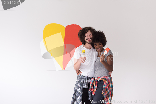 Image of couple with painted heart on wall