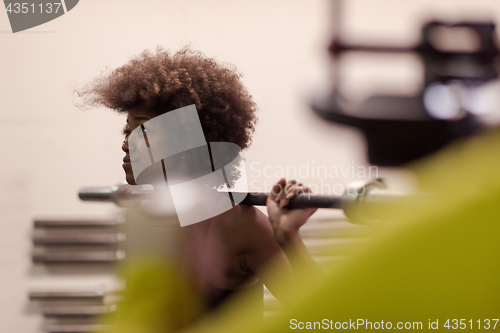 Image of black woman lifting empty bar