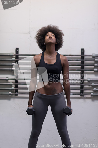 Image of black woman doing bicep curls