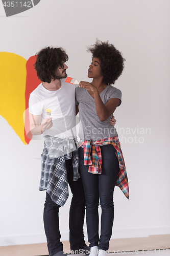 Image of couple with painted heart on wall