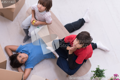 Image of boys with cardboard boxes around them top view