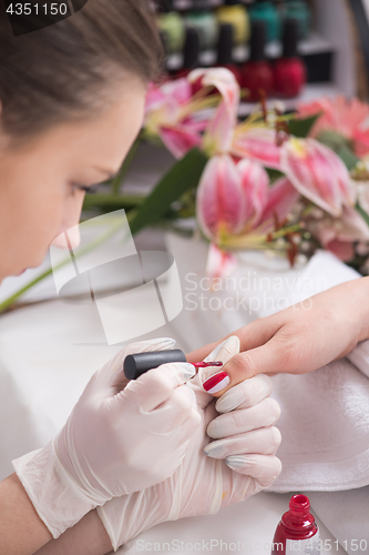 Image of Woman hands receiving a manicure