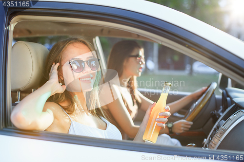 Image of The young women in the car smiling