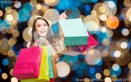 Image of happy woman with colorful shopping bags