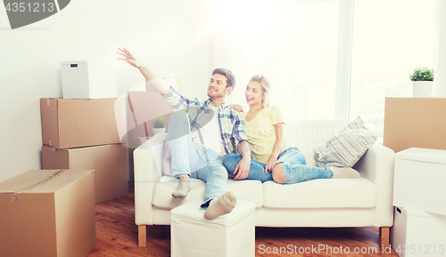 Image of couple with boxes moving to new home and dreaming