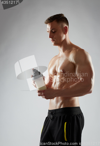 Image of young man or bodybuilder with protein shake bottle