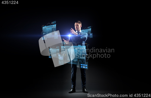 Image of businessman in suit with virtual projection