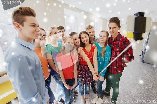 Image of group of students taking selfie with smartphone