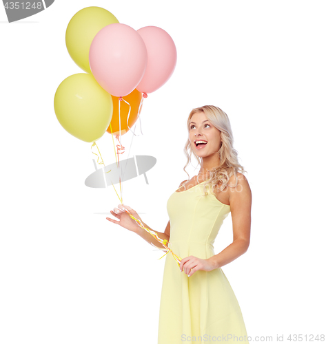 Image of happy woman in dress with helium air balloons