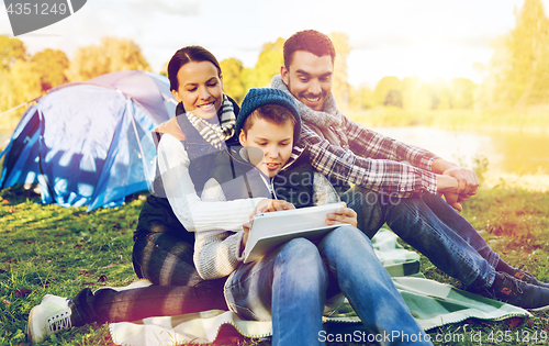 Image of happy family with tablet pc and tent at camp site