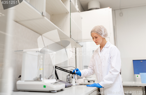 Image of scientist with flask making test at laboratory