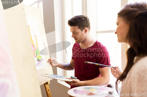 Image of artists painting still life picture at art school