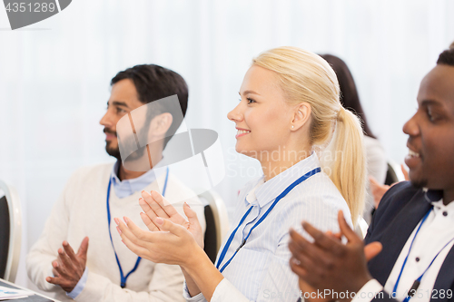 Image of people applauding at business conference