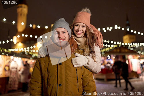 Image of happy couple hugging at christmas market