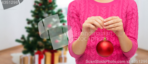 Image of close up of woman hands with christmas ball