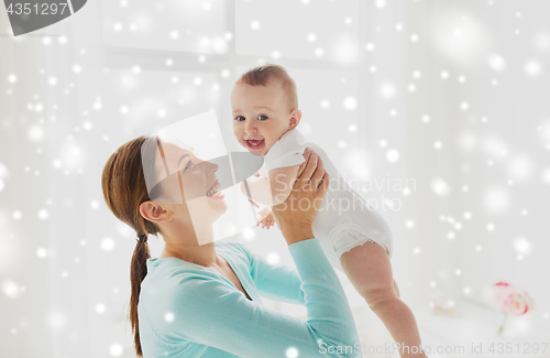 Image of happy young mother with little baby at home