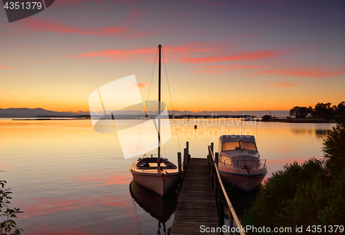 Image of Boats moored to jetty at sunrise