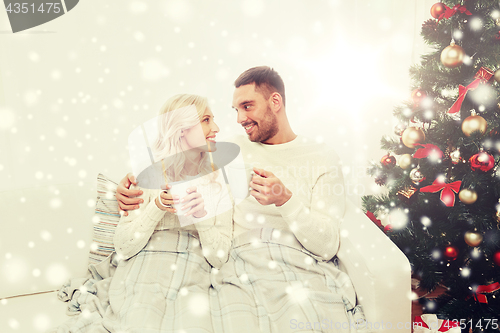 Image of happy couple at home with christmas tree