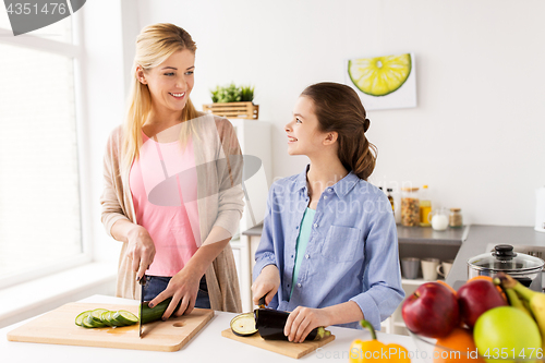 Image of happy family cooking vegetables at home kitchen