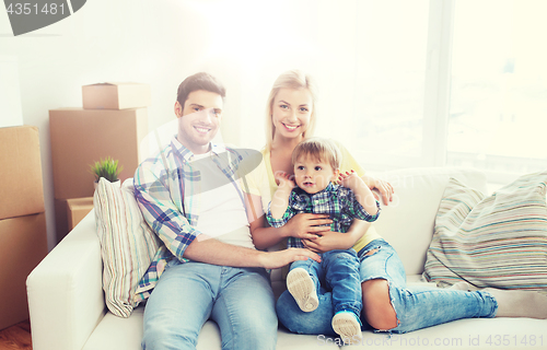 Image of happy family with boxes moving to new home