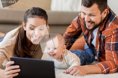 Image of mother, father and baby with tablet pc at home