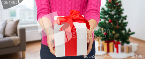 Image of close up of woman hands holding christmas gift