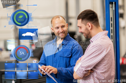 Image of auto mechanic with clipboard and man at car shop