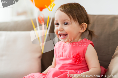 Image of happy baby girl on birthday party at home