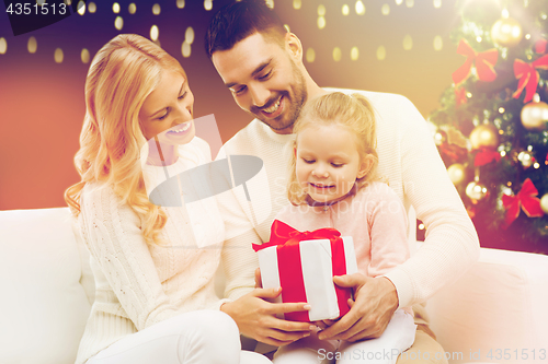 Image of happy family with christmas gift