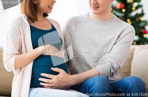 Image of close up of man and pregnant woman at christmas