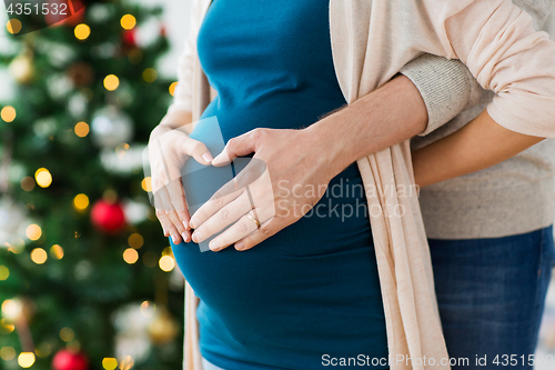 Image of close up of man and pregnant woman at christmas