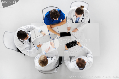 Image of doctors with cardiograms and tablet pc at hospital