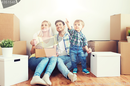 Image of happy family with boxes moving to new home