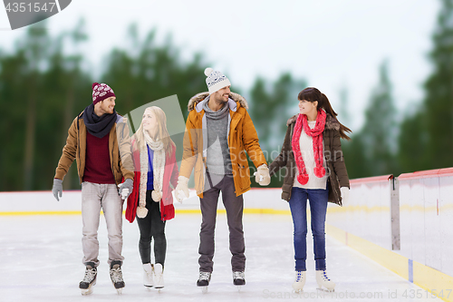 Image of friends holding hands on outdoor skating rink