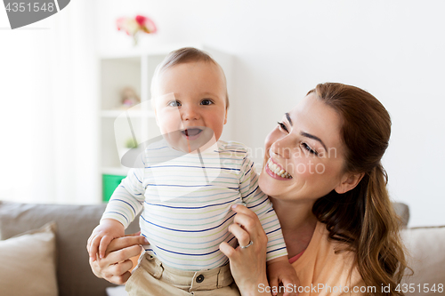 Image of happy young mother with little baby at home
