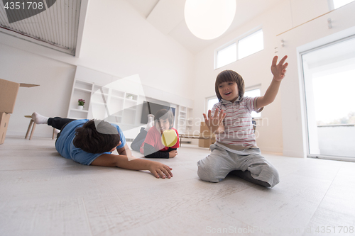 Image of boys having fun with an apple on the floor