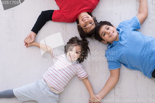 Image of young boys having fun on the floor