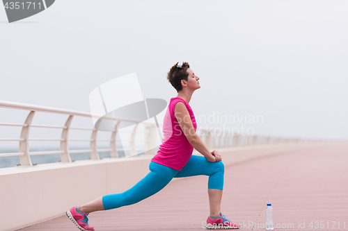 Image of woman stretching and warming up on the promenade