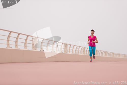 Image of woman busy running on the promenade