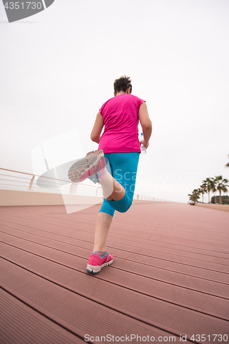 Image of woman busy running on the promenade