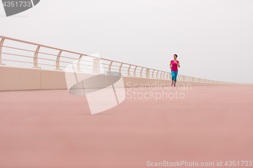 Image of woman busy running on the promenade