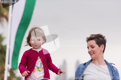 Image of mother and cute little girl on the promenade