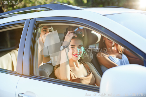 Image of The young women in the car smiling