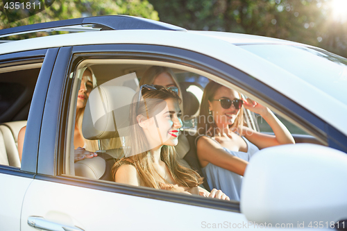 Image of The young women in the car smiling