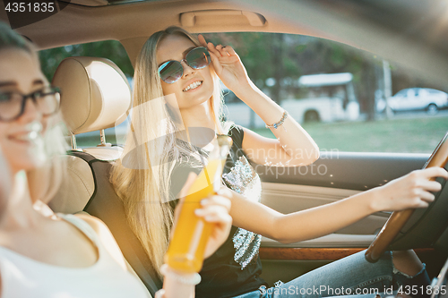 Image of The young women in the car smiling